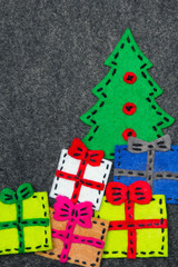 Christmas tree and colorful gifts on grey background.  Felt Christmas ornaments with copy space