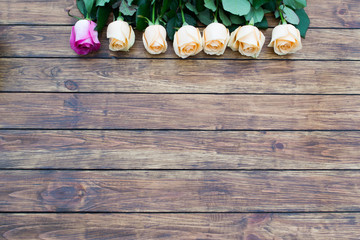 seven roses on a wooden background