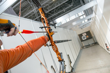 male archer shooting in competitions of the compound bow with arrows