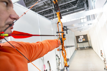 male archer shooting in competitions of the compound bow with arrows