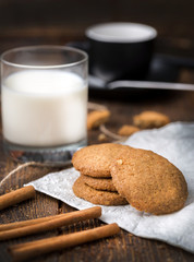 Biscuits with glass of milk on natural wooden table..