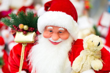 Toy Santa Claus and a teddy bear bear Christmas tree and gifts