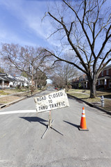 ROAD CLOSED TO THRU TRAFFIC sign on residential neighborhood street. Vertical.