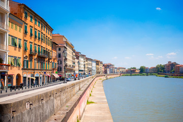Naklejka na ściany i meble View of italian city by river Pisa, Italy. Photo about european vacation