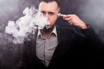Man using an advanced personal vaporizer or e-cigarette
