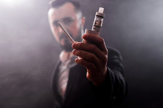 concept of choosing the type of cigarette, Close up of a smoker undecided about choosing the type of cigarette to smoke