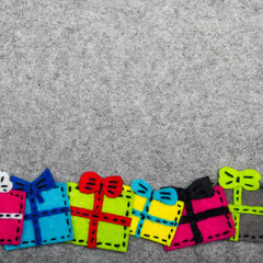 Christmas gifts on grey background.  Felt Christmas ornaments with copy space