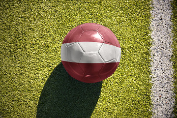 football ball with the national flag of latvia lies on the field