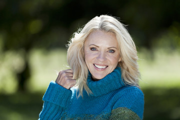 Portrait Of A Mature Woman Smiling At the Camera At The Park