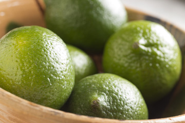 a bowl of whole fresh limes