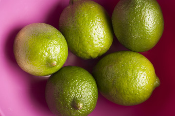 a bowl of whole fresh limes