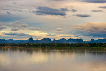 Stunning landscape in Lao PDR on the opposite Mekong river bank, viewed from Nakhon Phanom. Outstanding cloudscape at dusk.
