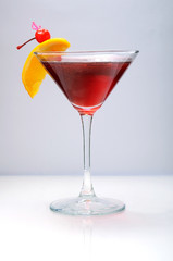 Alcohol cocktail with orange and cherry decoration
