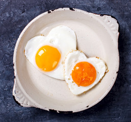 Fried egg in heart shape on the pan.Holiday Valentine's Day.Breakfast. Healthy Food.selective focus.