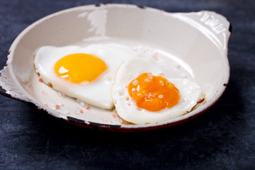Fried egg in heart shape on the pan.Holiday Valentine's Day.Breakfast. Healthy Food.selective focus.