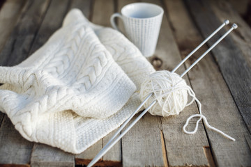 Beautiful white knitting and cup of tea