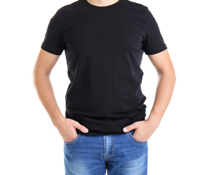 Handsome young man in blank black t-shirt on white background, close up