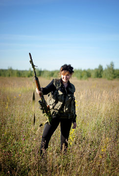 A girl with a gun in his hands