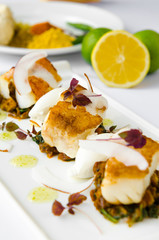 Fresh pan seared, crispy golden cod fish fillet, served on a bed of curried cauliflower, spinach and potato. A beautiful seafood dish.