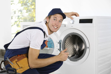 Plumber repairing washing machine