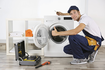 Plumber repairing washing machine