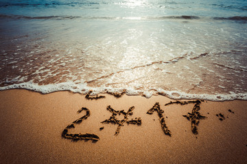 Happy New Year 2017, lettering on the beach. Instagram effect (vintage).