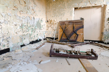 An old abandoned grand piano,with broken keys,  in an abandoned building. Exploring urban decay.