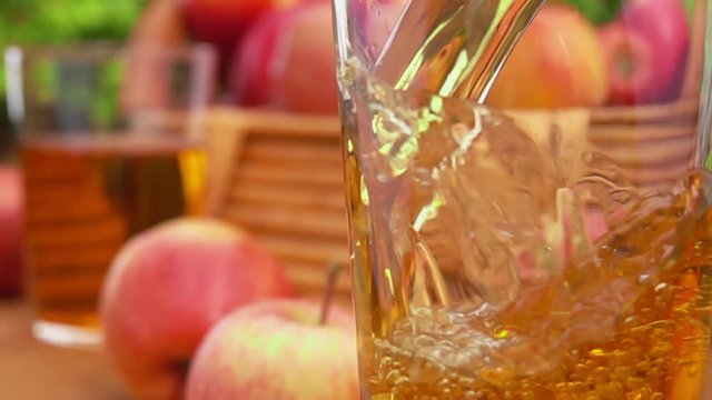Apple juice apple juice is poured into a glass and basket apples