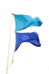 blue flags on the pole waving in the wind