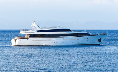Fototapeta na wymiar luxury private motor yacht under way on tropical sea with bow wave