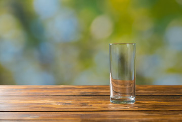Empty glass on wooden table outdoor