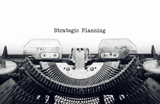 Vintage typewriter on white background with text Strategic Planning