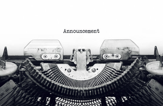 Vintage typewriter on white background with text Announcement.
