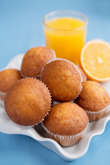 Baking and orange juice on a tray on a blue background