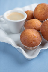 Pastries and coffee on a tray on a blue background