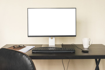 Computer with white screen on the desk.