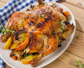Homemade Orange Whole Chicken on a white plate.