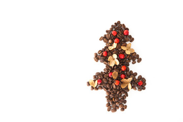 Christmas tree made of coffee beans decorated with red wild rose berries and dry flowers isolated on white background.  Winter and new year theme.
