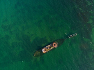 Looking straight down from the air at historic shipwreck of HMVS Cerberus in shallow turquoise...