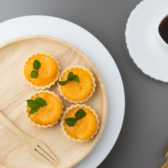 cake basket on a table,orange cake with black coffee.