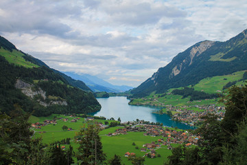 Fototapeta na wymiar Blue Lake in a Valley in Switzerland