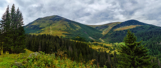 Fototapeta na wymiar Beautiful mountain wide panorama with views of the high peak