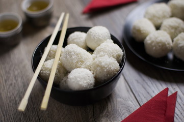 Homemade chinese Tang Yuan dumplings with coconut sprinkles in b