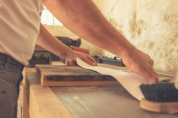 Carpenter working on raw wood.