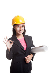 Asian engineer woman with blueprints show OK hand sign.