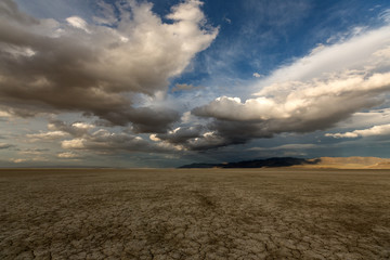 Big puffy clouds over a parched desert landscape