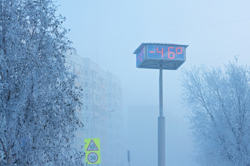Fototapeta premium Temperature indicators on city board. Abnormally low air temperature,-46 degrees. Russia, Western Siberia.