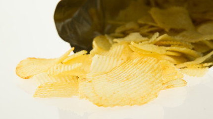 Open bag with potato chips isolate on white background...