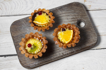 Homemade desserts with fruits for the new year. Desserts for the holidays. Side and top view. On a wooden background