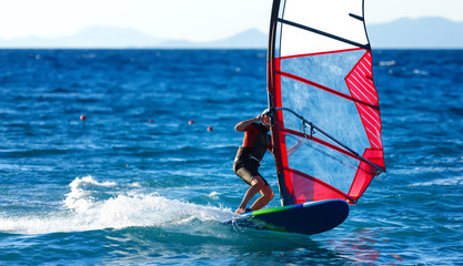 windsurfer close-up on crest of a wave rotates